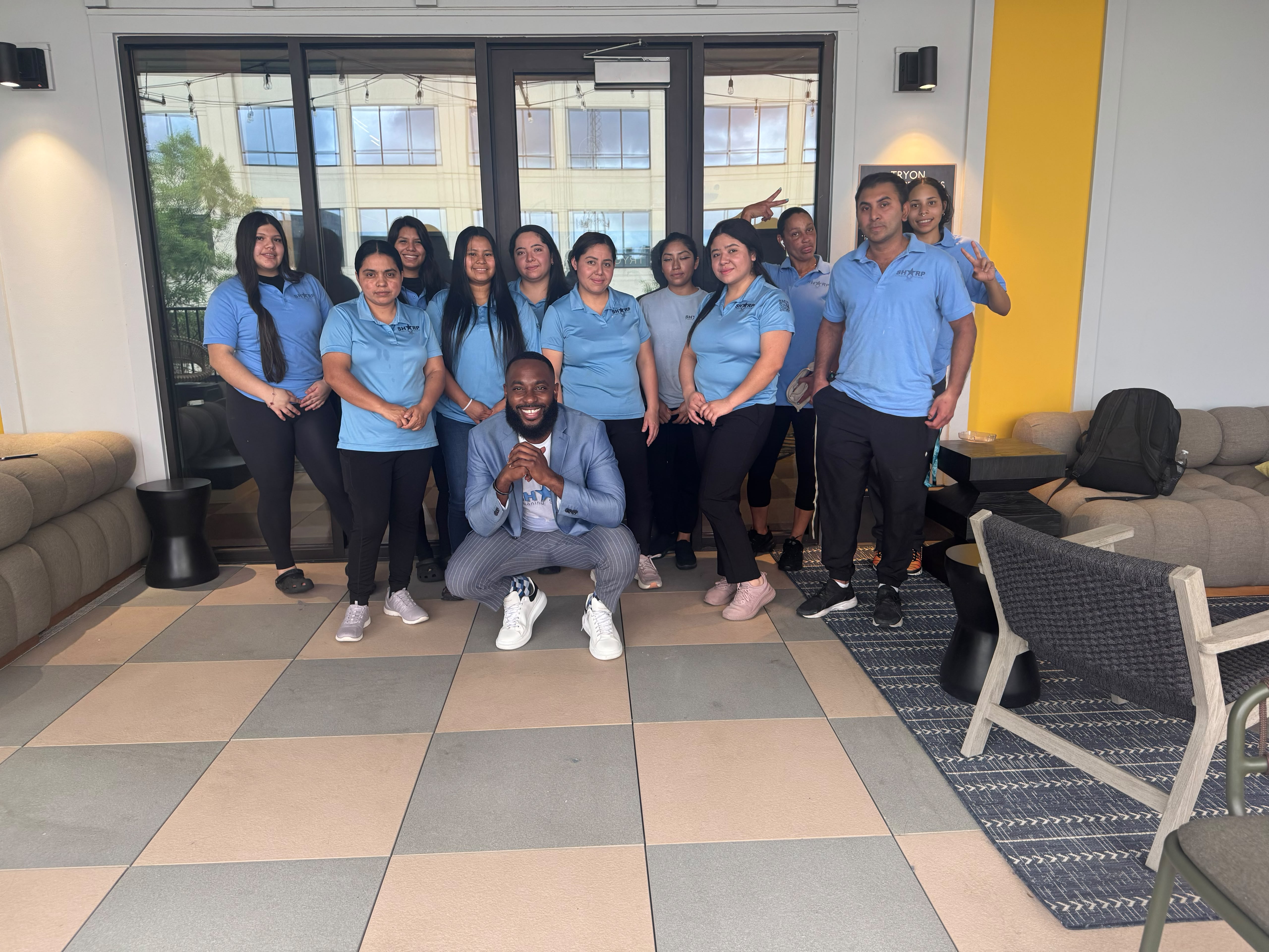 Sharp Cleaning crew lined up in branded uniforms
