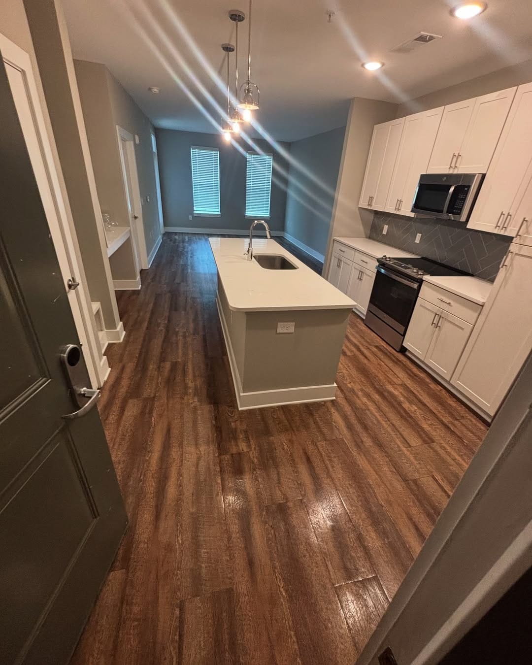 Freshly mopped hardwood floors in a move-in ready apartment